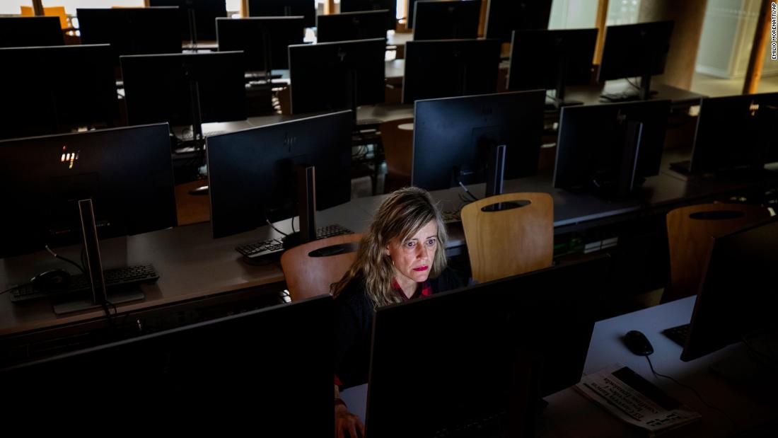 A teacher works in an empty classroom at the Pompeu Fabra University in Barcelona, Spain.